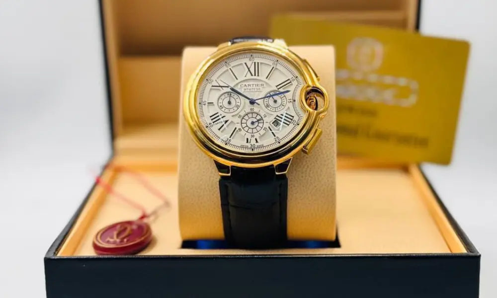 Luxury watch with gold case and black strap in a branded box