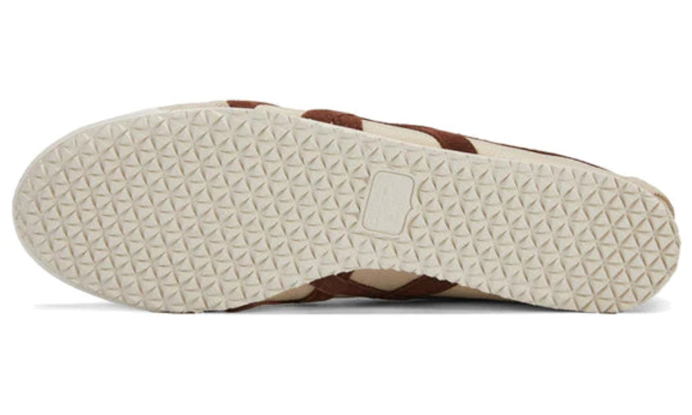 Close-up of a shoe sole with a brand logo on a white background