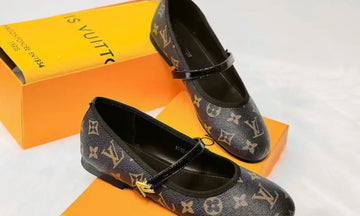 Louis Vuitton shoes with monogram pattern on an orange box
