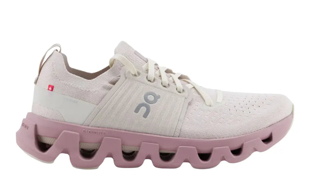 White running shoe with pink sole on a white background