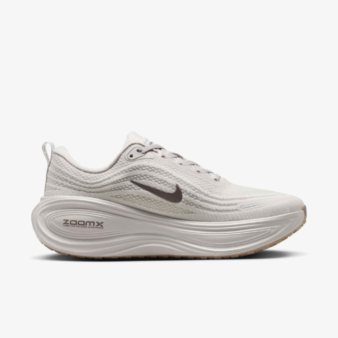 White running shoe with Nike logo and 'zoomx' text on a white background