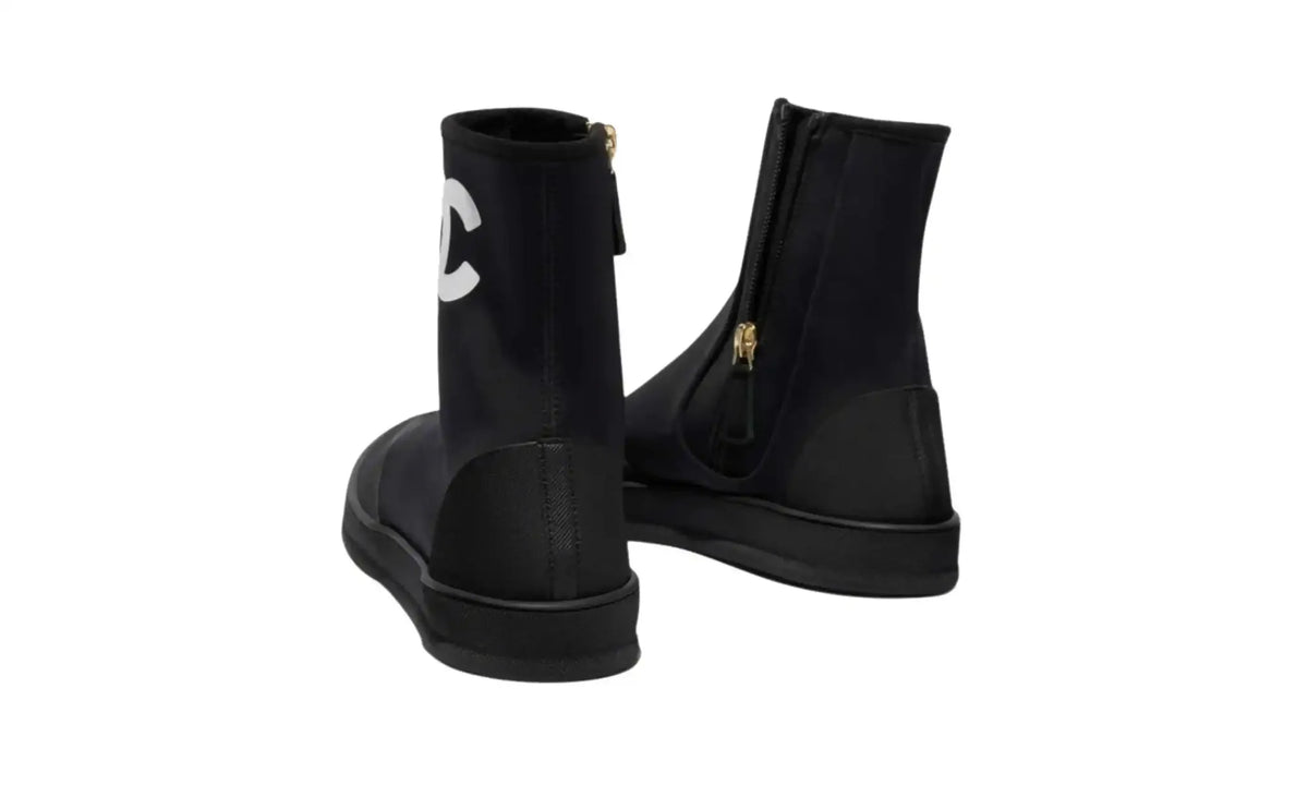 Chanel Black White Short Boots for Women, rear pair view showing zip closures, tonal heel overlays and low-profile black soles