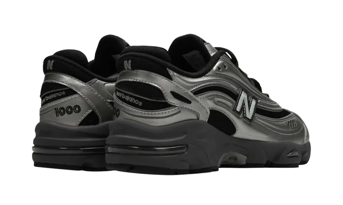 New Balance 1000 Black Metallic Silver unisex sneakers, rear angled view showing heel detailing