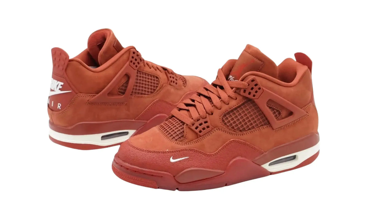 Angled view of Nigel Sylvester Air Jordan 4 Brick by Brick sneakers in Firewood Orange