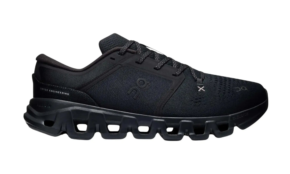 On Cloud X 5 Black unisex shoes, outer side view showing black mesh-style panels, tonal logos, patterned laces, light-grey X detail and dark sole openings