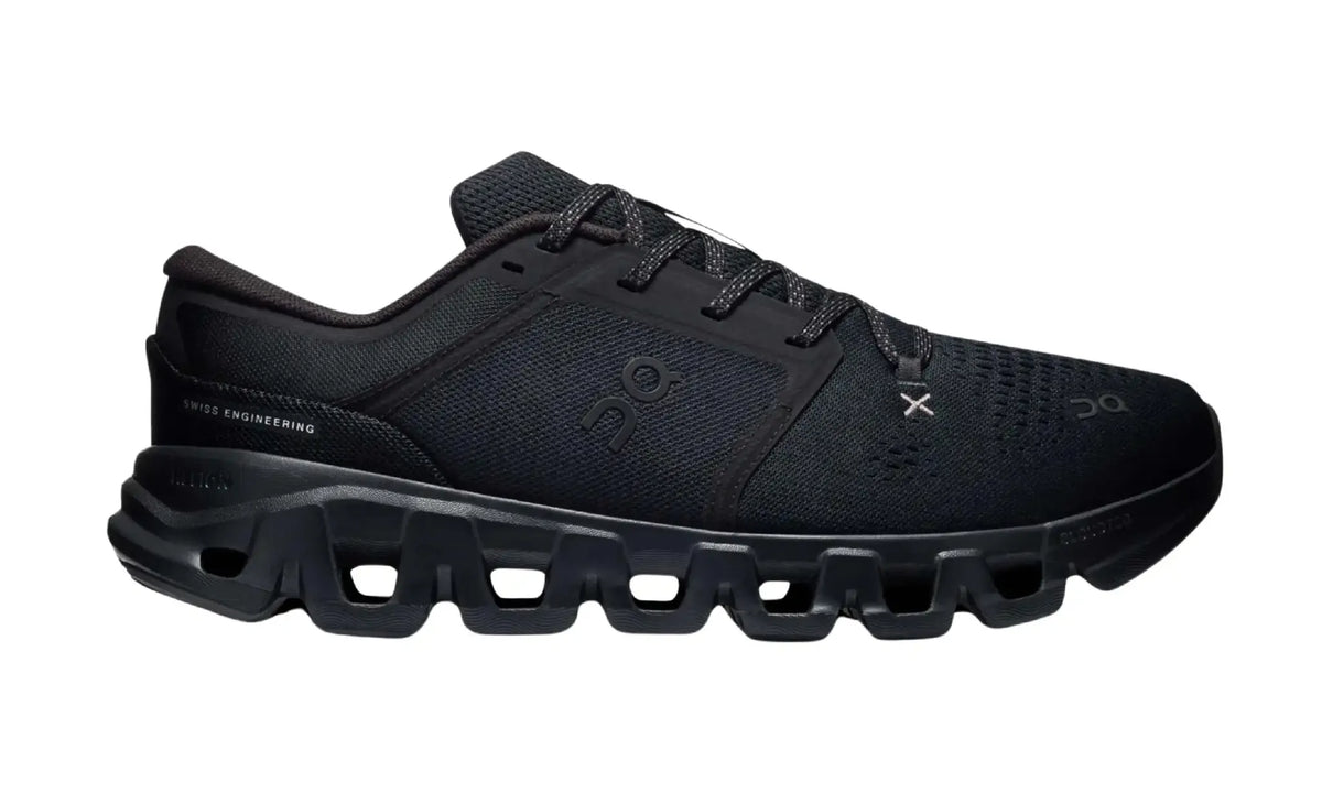 On Cloud X 5 Black unisex shoes, outer side view showing black mesh-style panels, tonal logos, patterned laces, light-grey X detail and dark sole openings