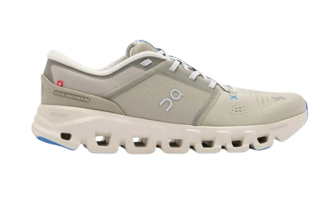On Cloud X 5 Brume Pearl unisex sneaker side view with grey-beige mesh-style upper, grey logos, blue accents, red Swiss-cross heel detail and pearl-toned sole openings