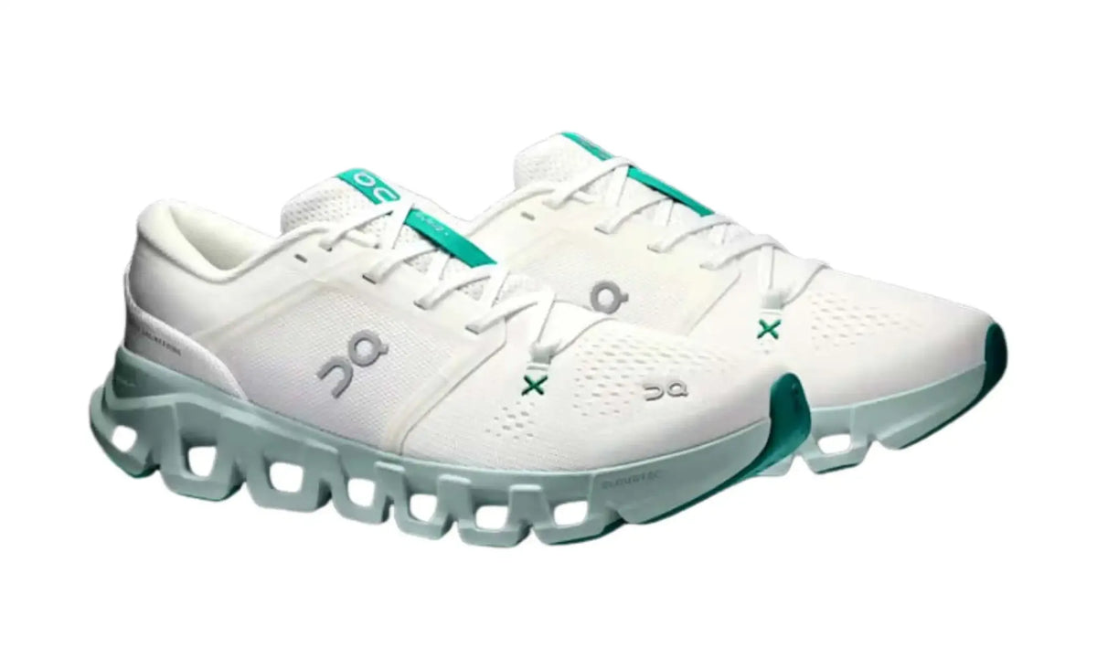 On Cloud X 5 Ivory Surf unisex shoes, angled pair view showing green accents, grey On logos and mint soles