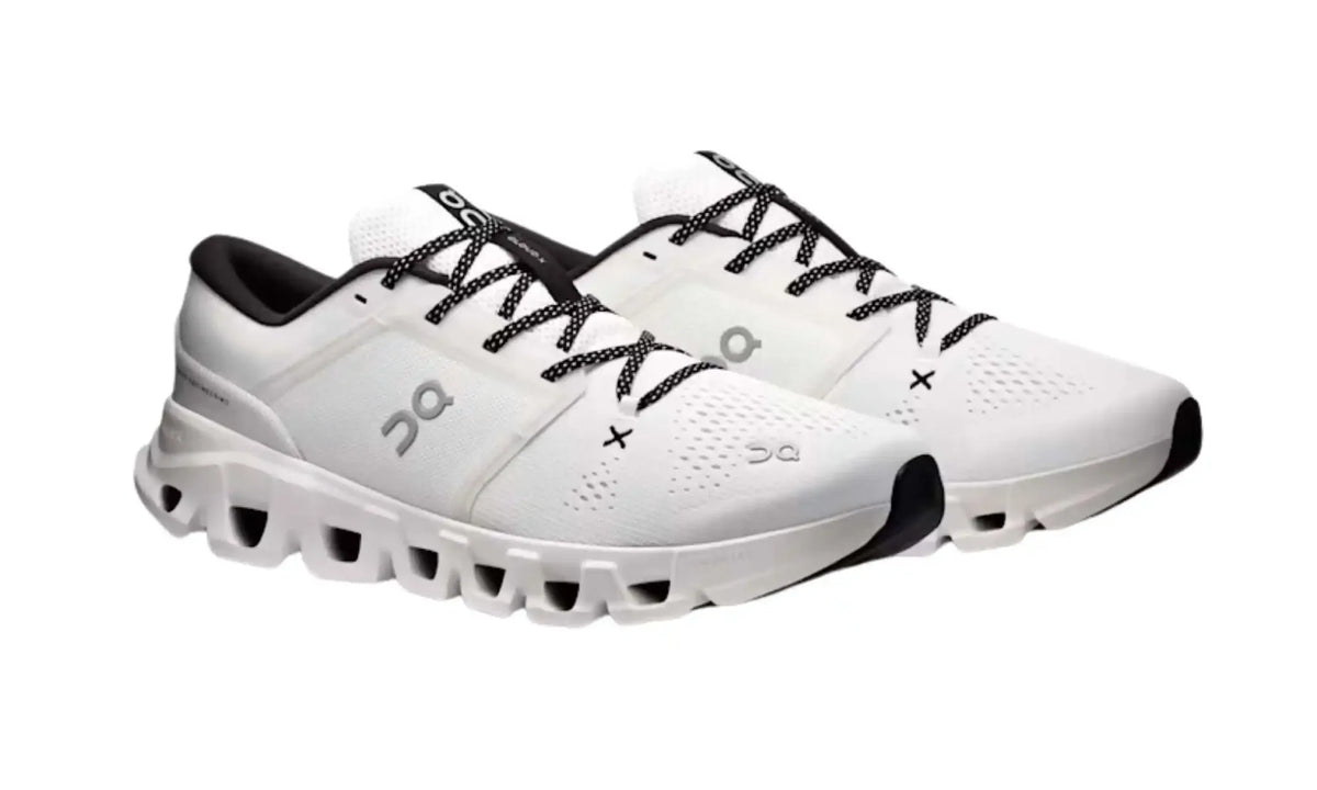 On Cloud X 5 White Black unisex shoes, angled pair view showing white uppers, grey On logos, black details and sculpted white soles