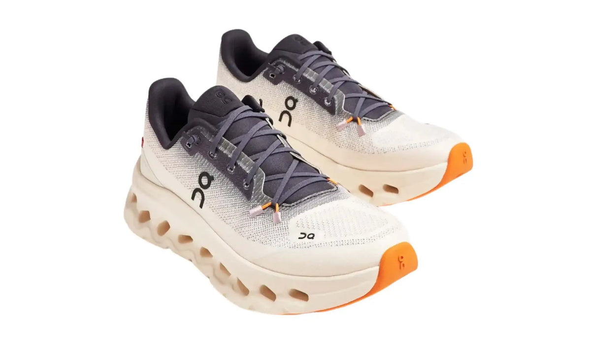 Side profile of On Cloudtilt Iron/Dew women's sneakers showing the open-cloud sole
