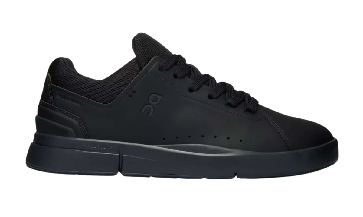 On THE ROGER Advantage All Black sneaker, side view showing tonal On branding, black laces and black sole