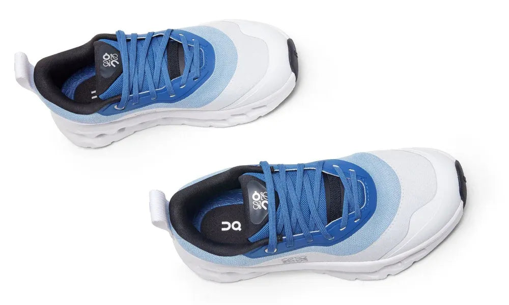 Pair of blue and white athletic shoes on a white background