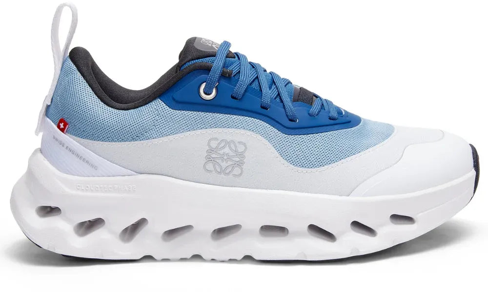 Blue and white sneaker with visible brand logo on a white background