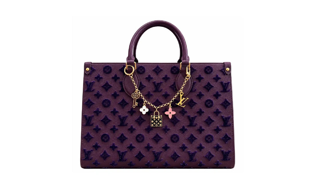 Front view of Purple OnTheGo MM monogram tote bag with gold-tone charm chain and top handles