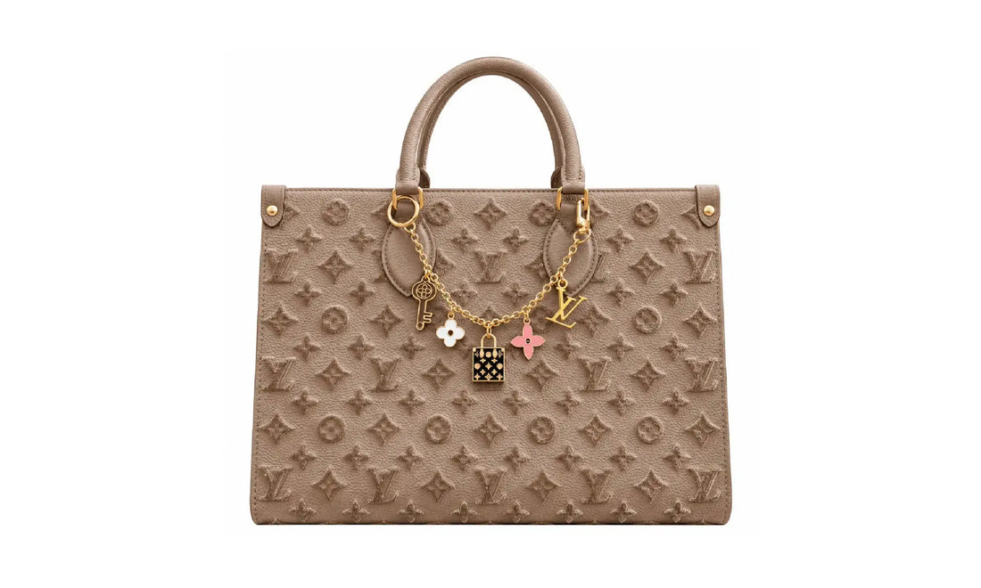 Front view of Taupe OnTheGo MM monogram tote bag with gold-tone charm chain and top handles