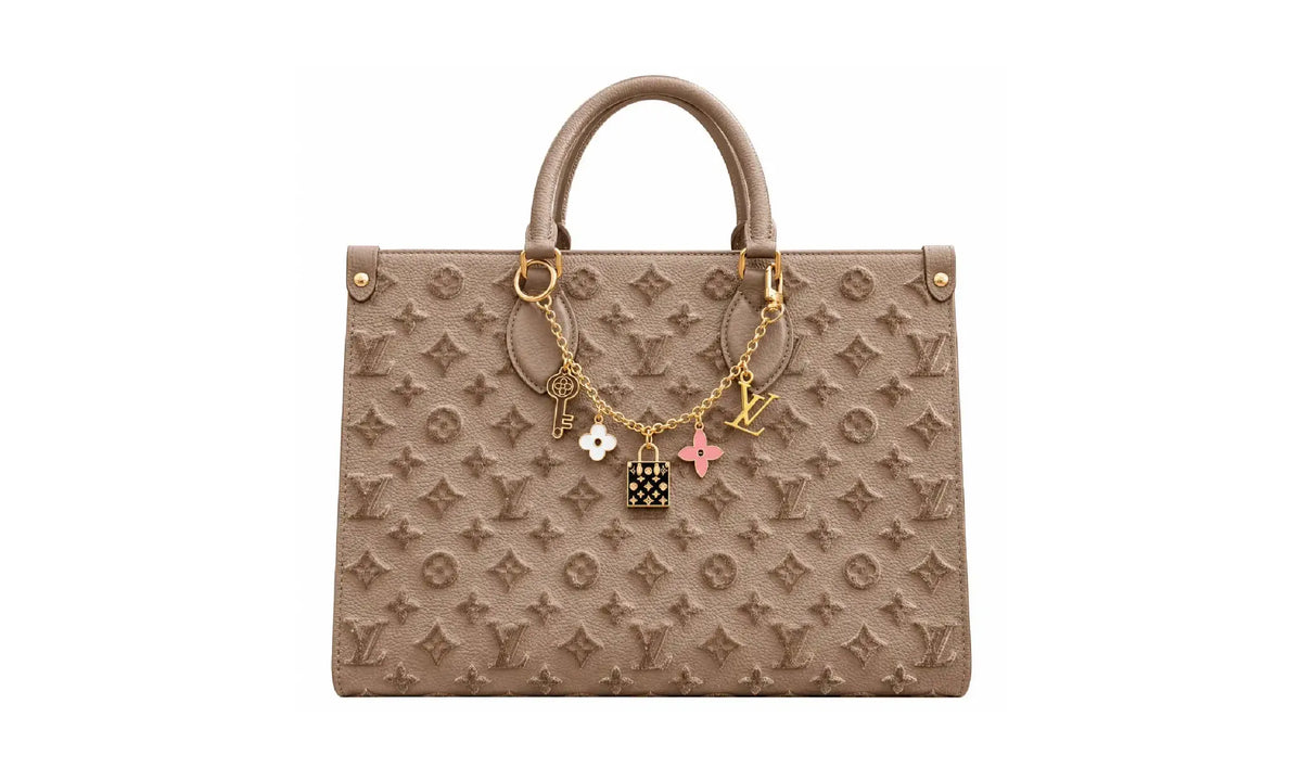 Front view of Taupe OnTheGo MM monogram tote bag with gold-tone charm chain and top handles