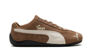Brown Puma sneaker with white accents on a white background