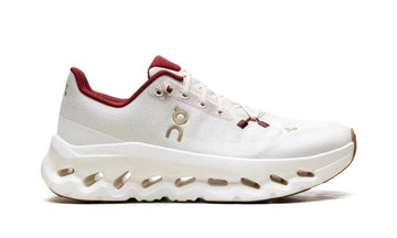 White sneaker with red accents on a white background