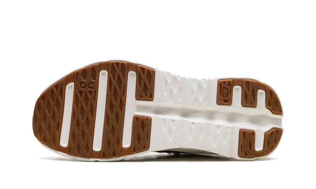 Close-up of a shoe sole with brown and white design on a white background