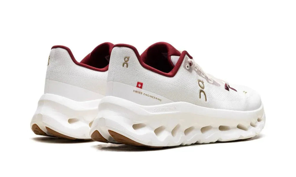 White sneakers with red accents on a white background