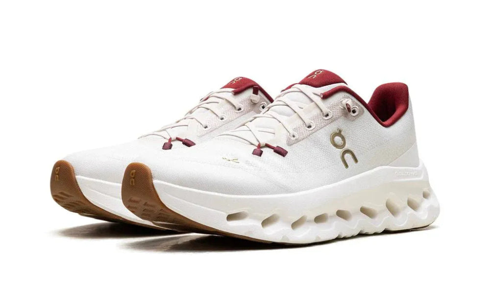 White sneakers with red accents on a white background