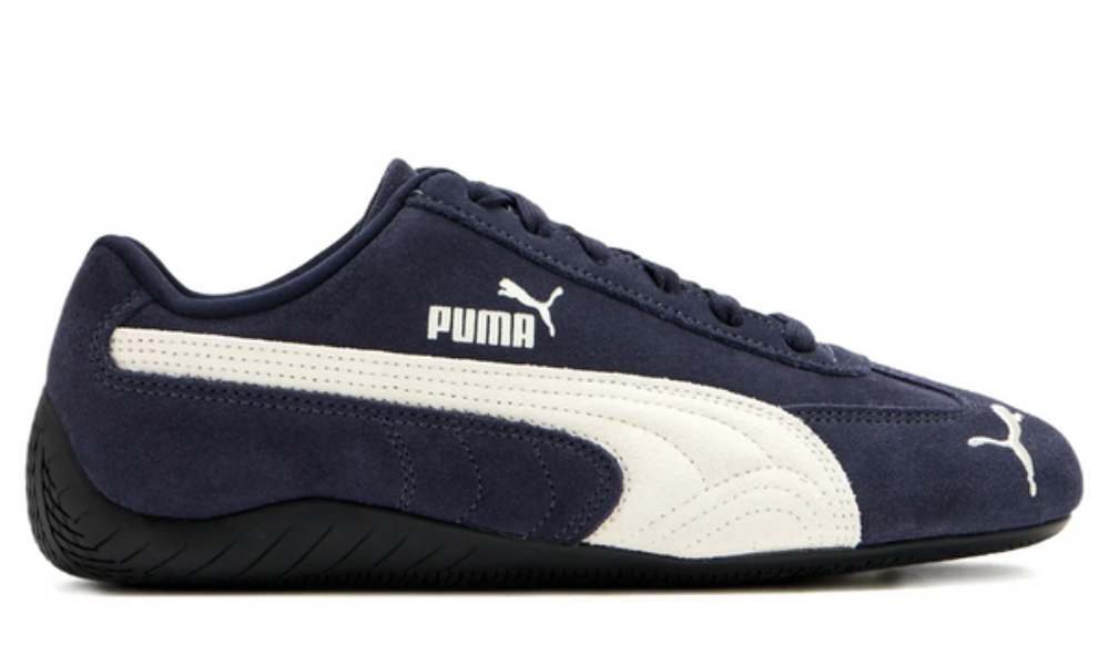Navy blue and white Puma sneaker on a white background